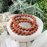 Mala Red Sandstone Bracelet With Velvet Pouch